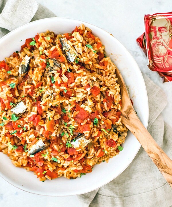 Spanish rice in a serving bowl with sardines