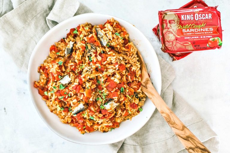 Spanish rice in a serving bowl with sardines