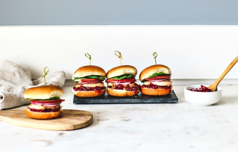 Stacked salmon sliders lined up in a row.