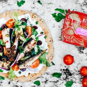 Pita topped with tzatziki, fresh veggies, and Mediterranean sardines.