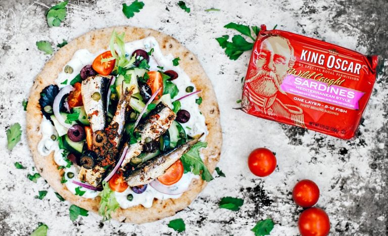 Pita topped with tzatziki, fresh veggies, and Mediterranean sardines.