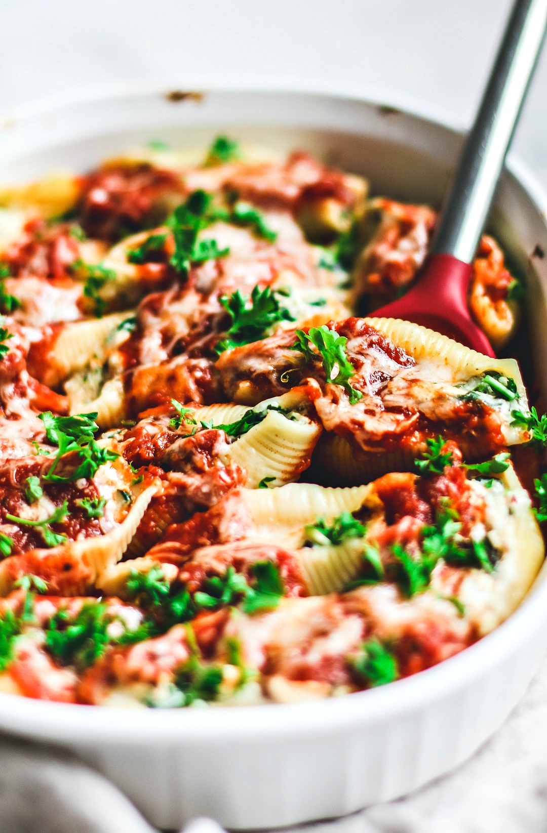 Close up of stuffed shells in baking dish.