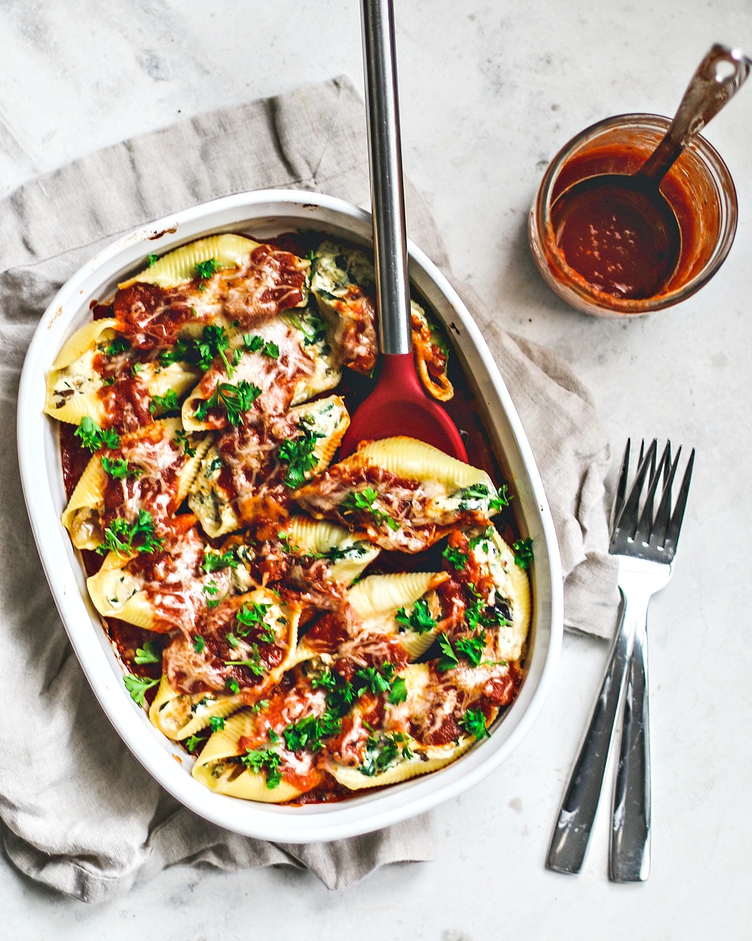 Baking dish full of stuffed pasta shells.