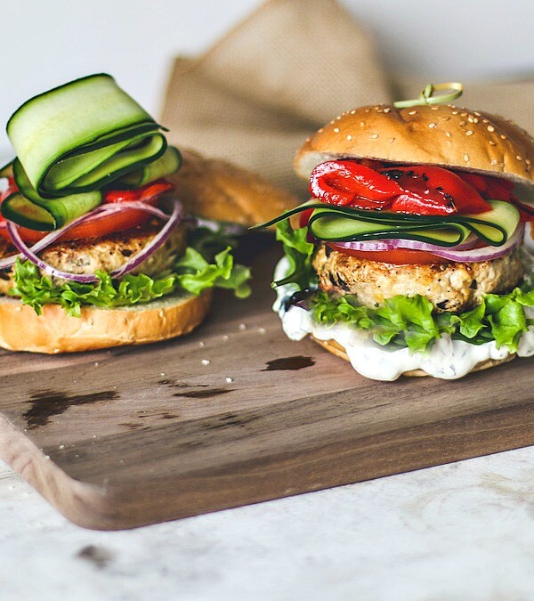 Greek Turkey Burgers stacked with fresh toppings.