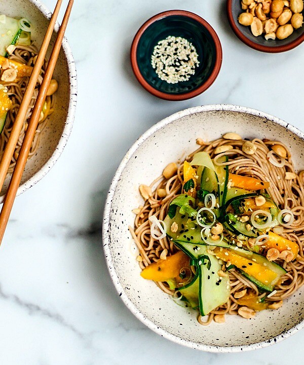 Bowls of sesame noodles with cucumber and mango salad.