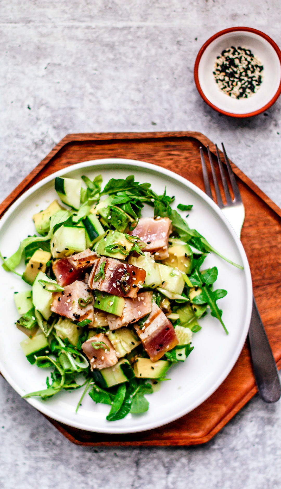 Plate of salad with grilled tuna on top.