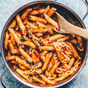 Penne tossed in easy marinara sauce in a serving pan.