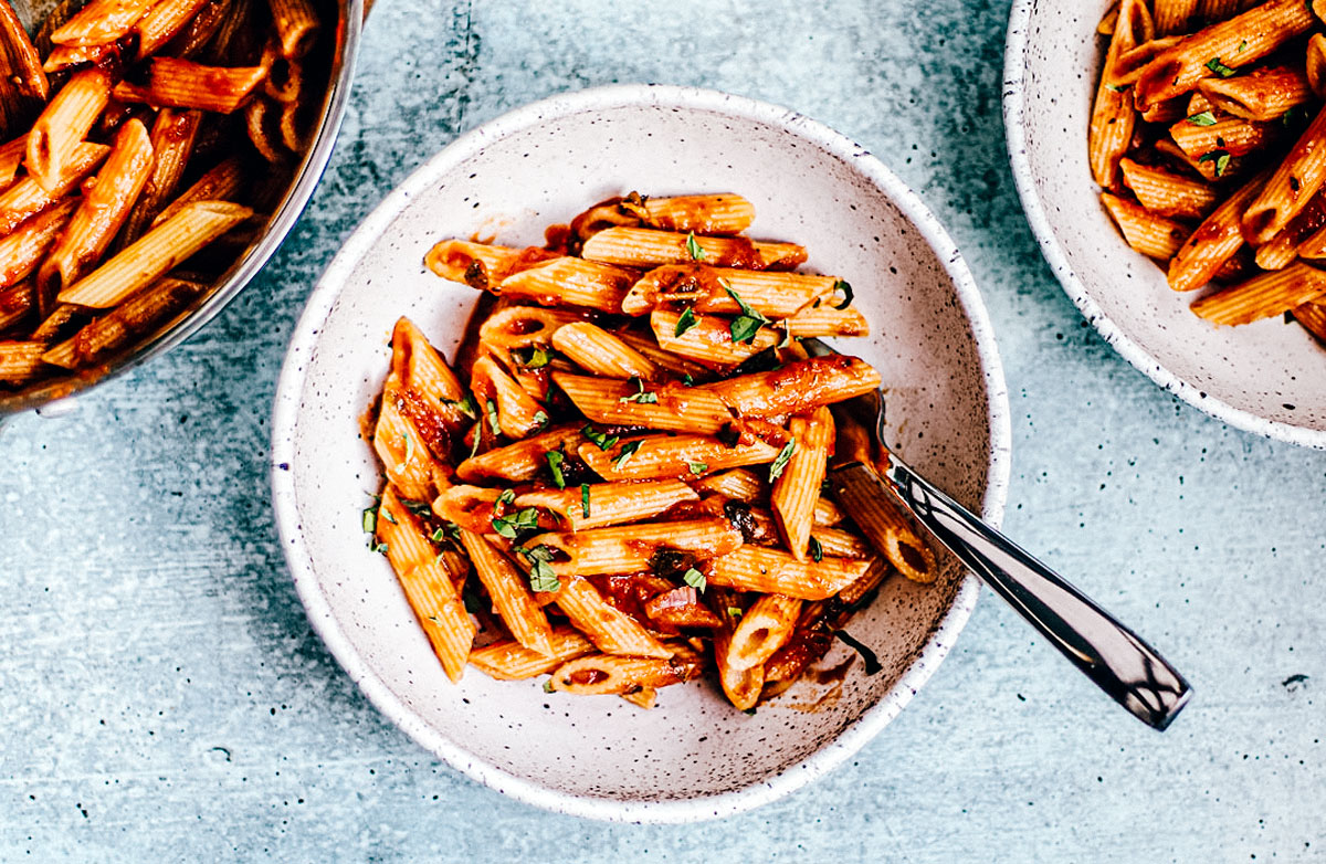 Bowls of penne tossed in easy marinara sauce.