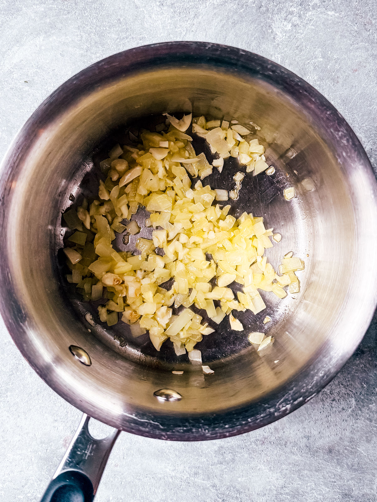 Cooked onions in saucepan.