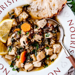 Turkey and wild rice soup in a bowl with a spoon.