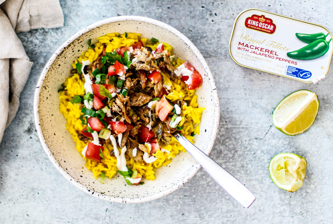 Bowl of golden rice, mackerel, tomatoes, and scallions.