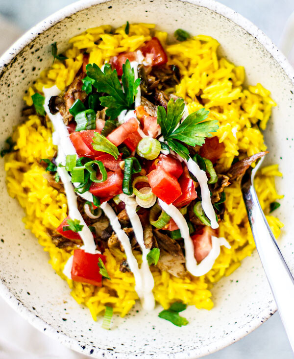 Bowl of golden rice, mackerel, tomatoes, and scallions.