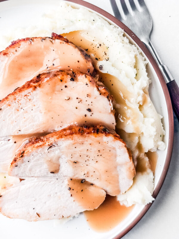 Oven roasted turkey on mashed potatoes with gravy.