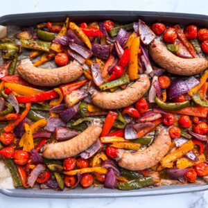 Sheet pan of turkey sausages and vegetables.