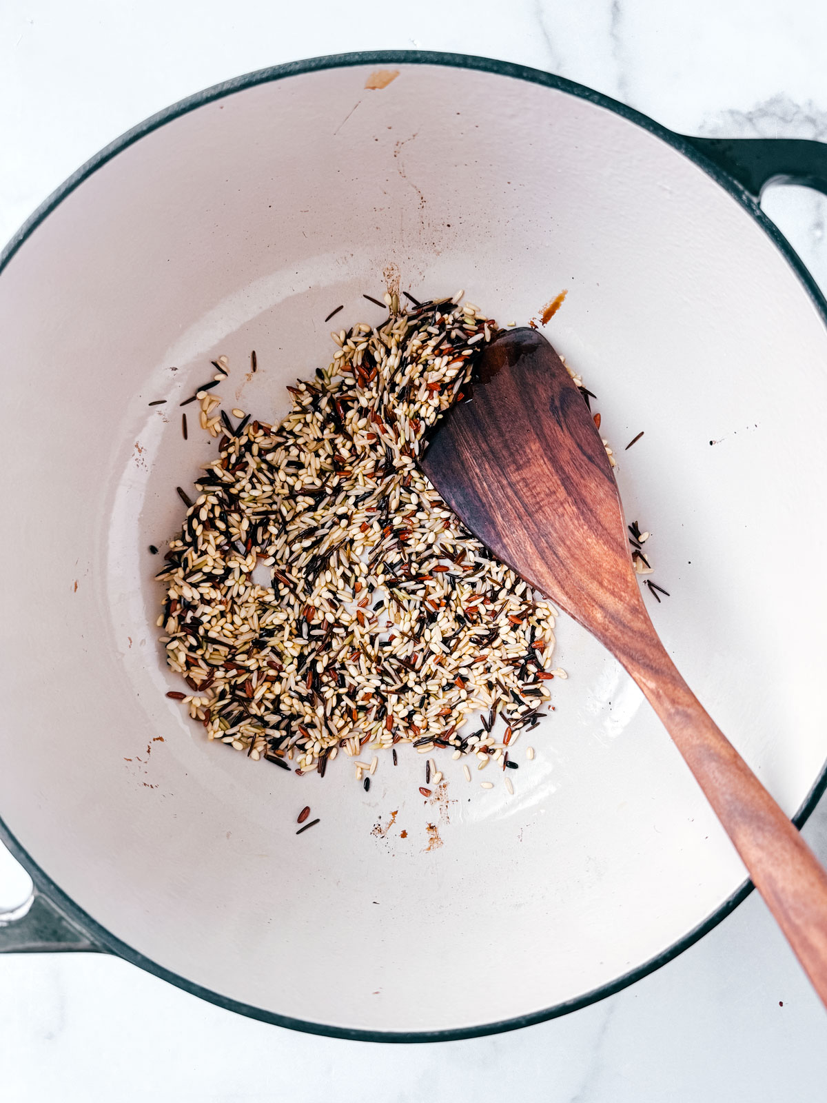 Wild rice being toasted in a pot.