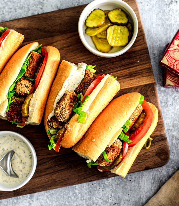 Po'Boy Sandwiches lined up on a cutting board.