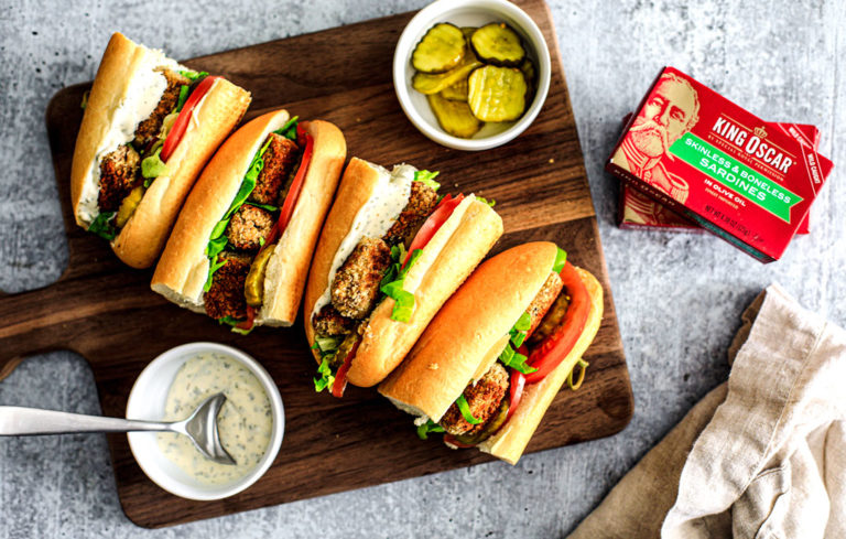 Po'Boy Sandwiches lined up on a cutting board.