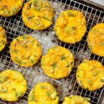 Cheesy egg muffins on a cooling rack.