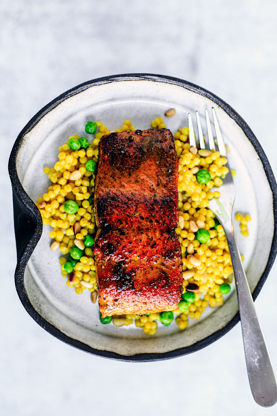 Pan-seared salmon over bed of couscous and peas.