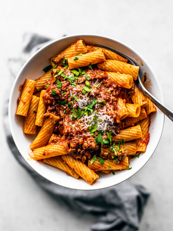 Overhead shot of bowl of rigatoni topped with turkey bolognese.