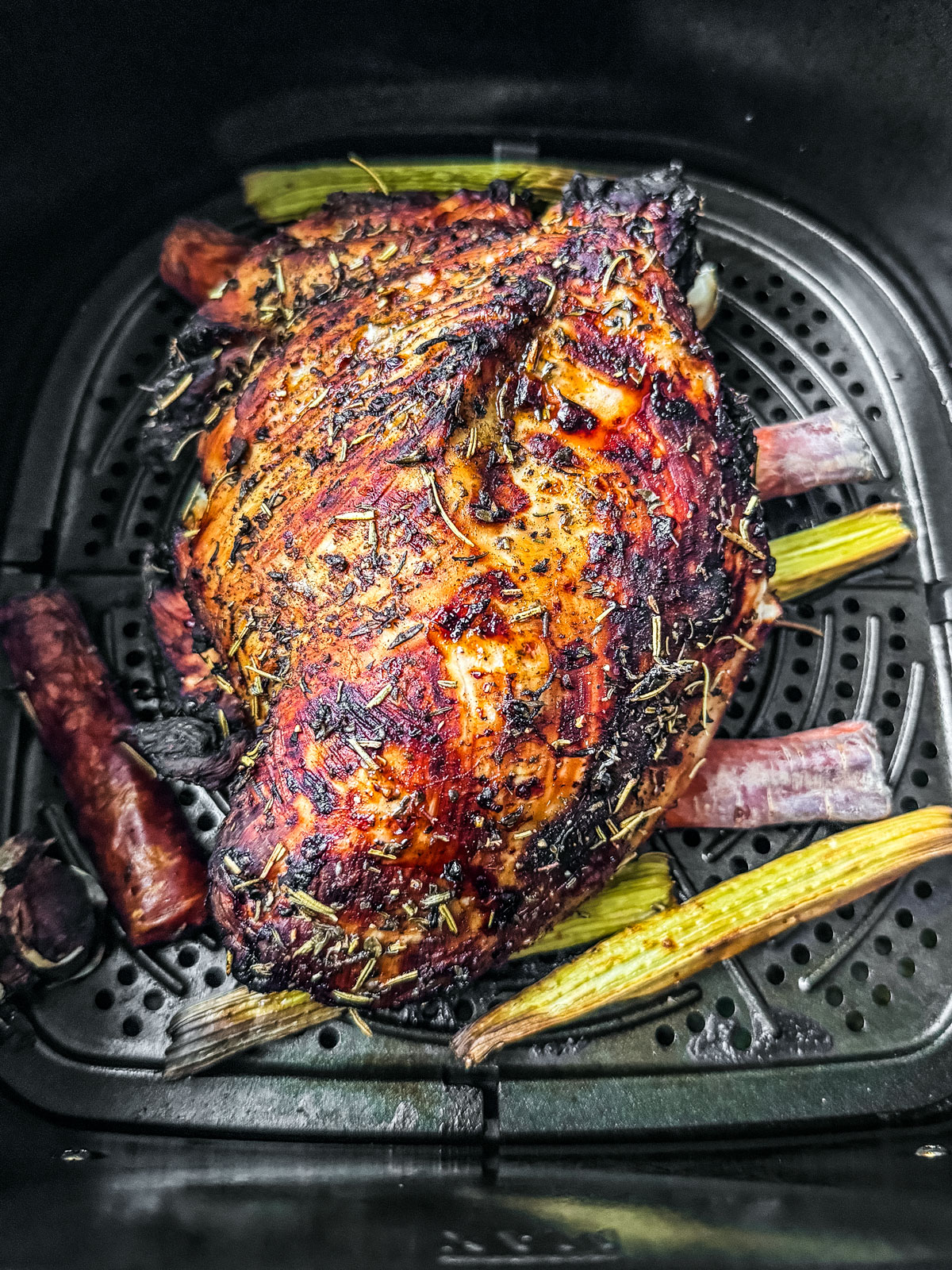 Fully cooked golden brown turkey breast in the air fryer basket.