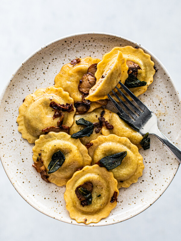 Plate of mushroom ravioli with a fork.