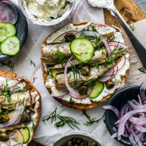 Close up of bagel with cream cheese and sardines.