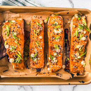 Fillets of miso salmon on a baking sheet.