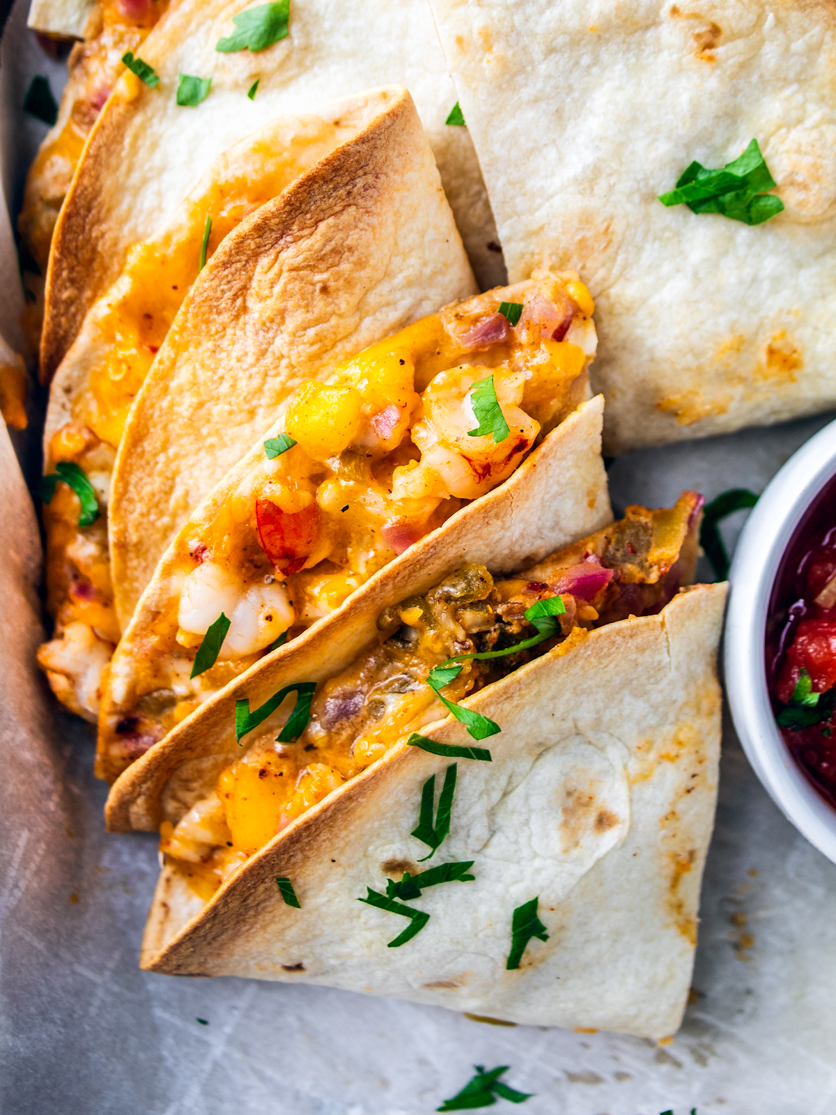 Close up of shrimp fajita wedges on a baking sheet.