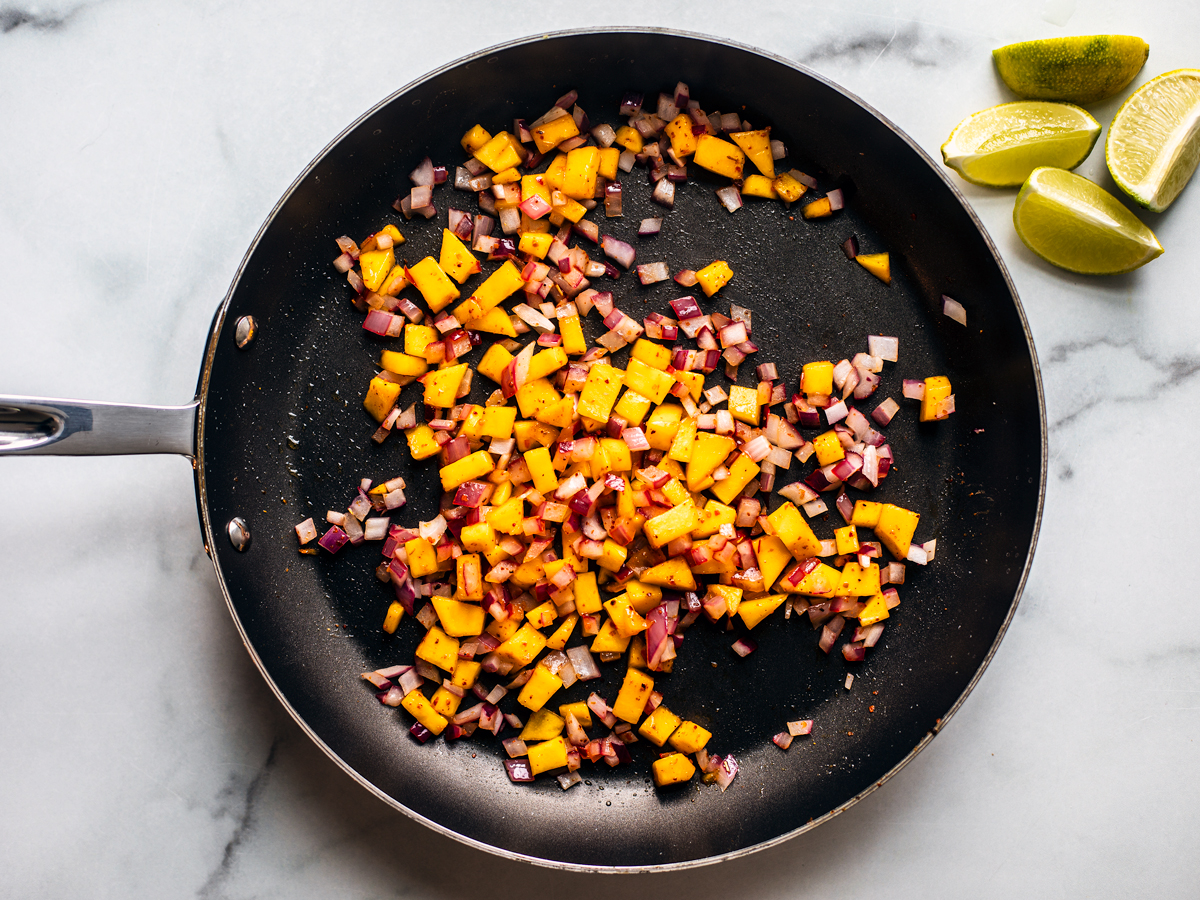 Pan with cooked onions and mango.