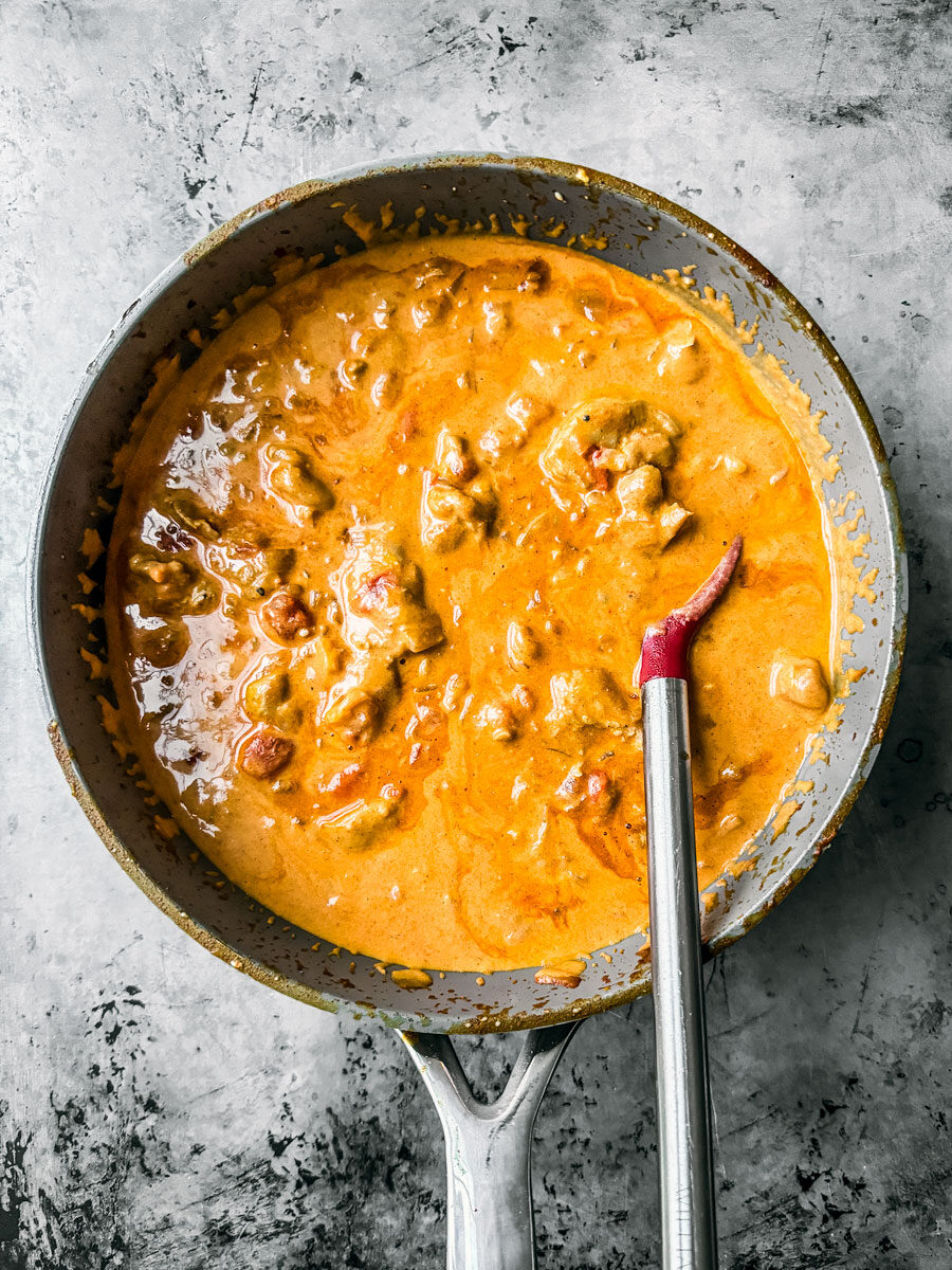 Chicken in pan with creamy paprikash sauce.