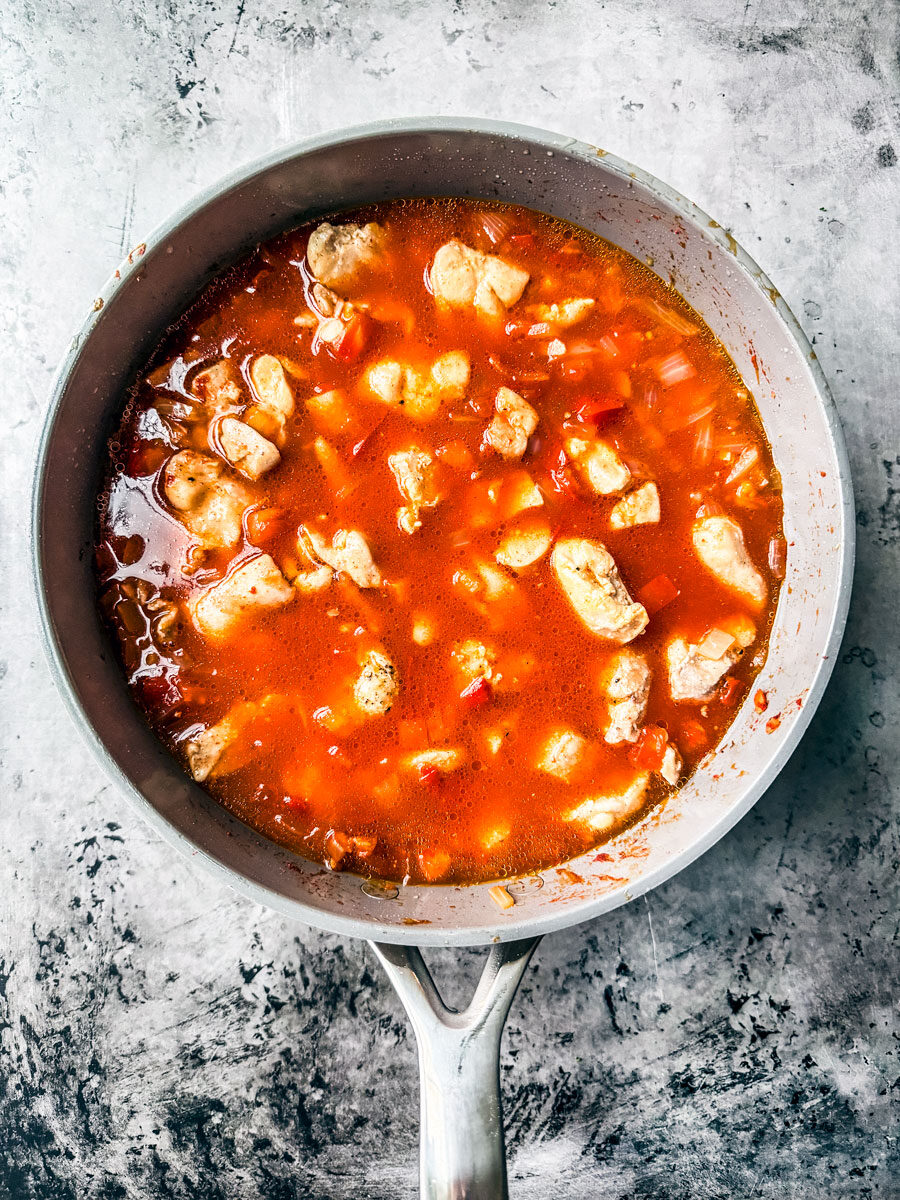 Pan of chicken in sauce.