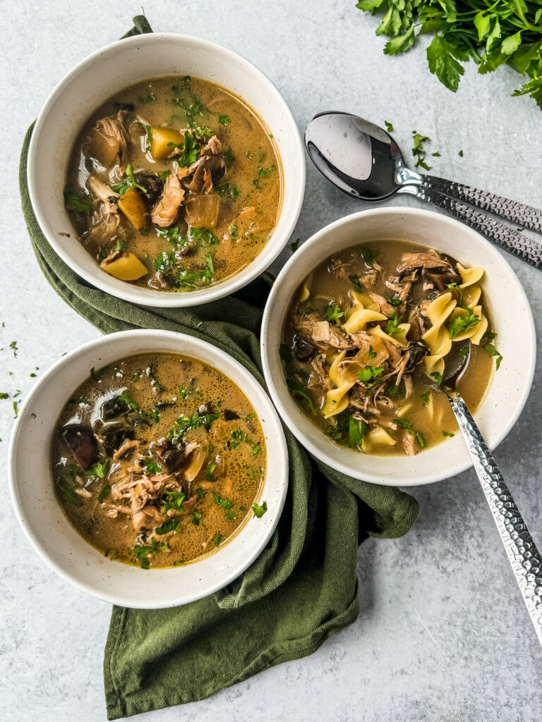 Three bowls of chicken marsala soup.