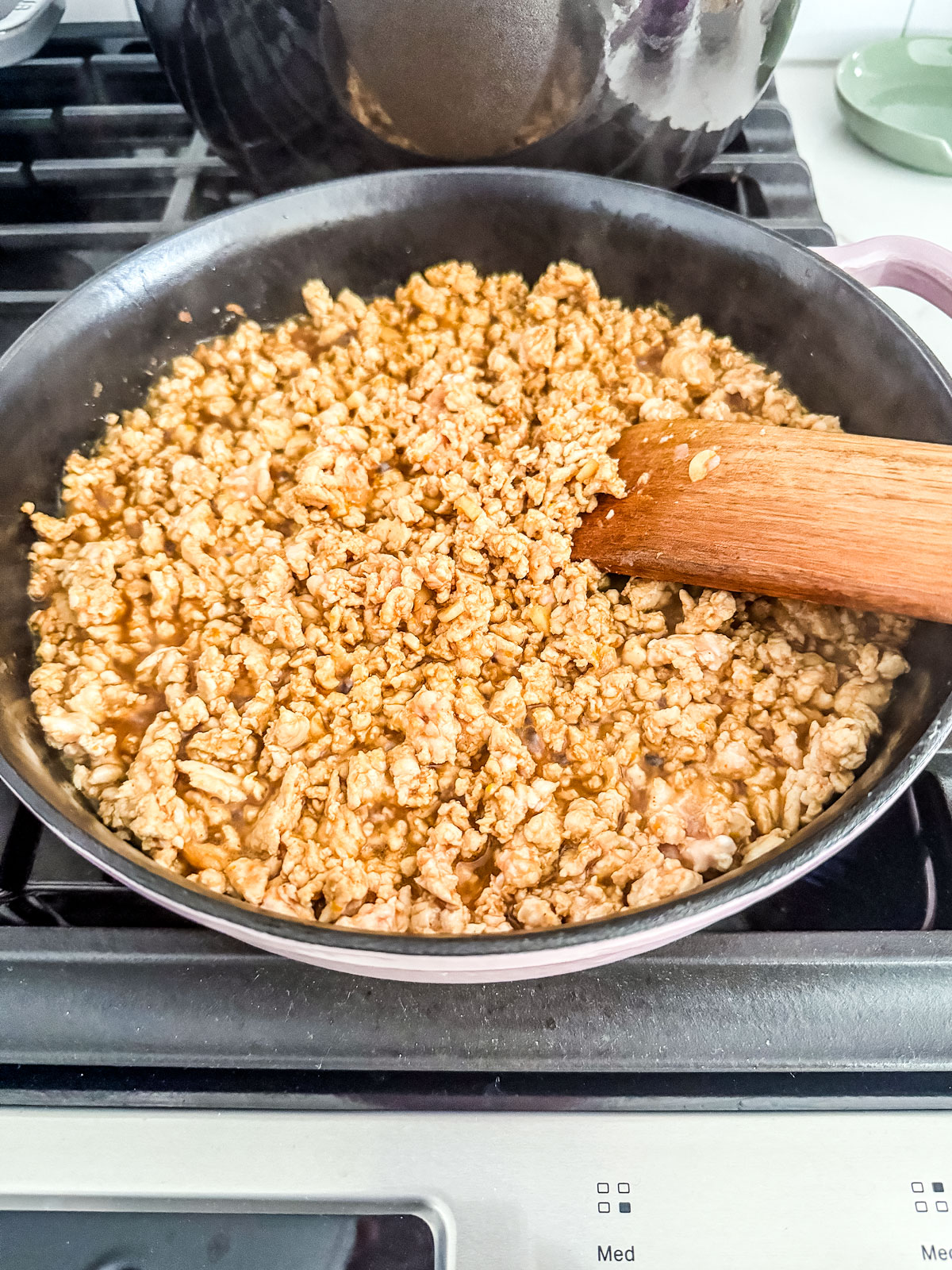 Ground turkey crumbled in a pan.