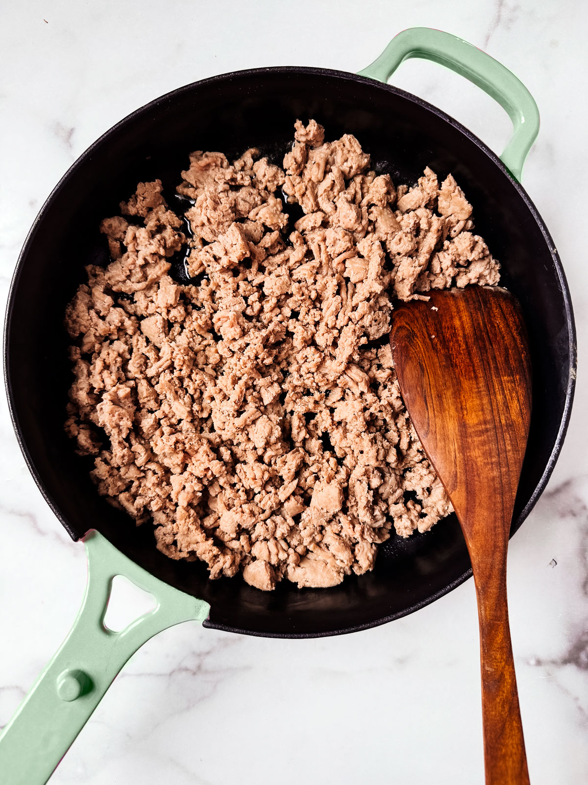 Ground turkey, cooked, in a skillet.