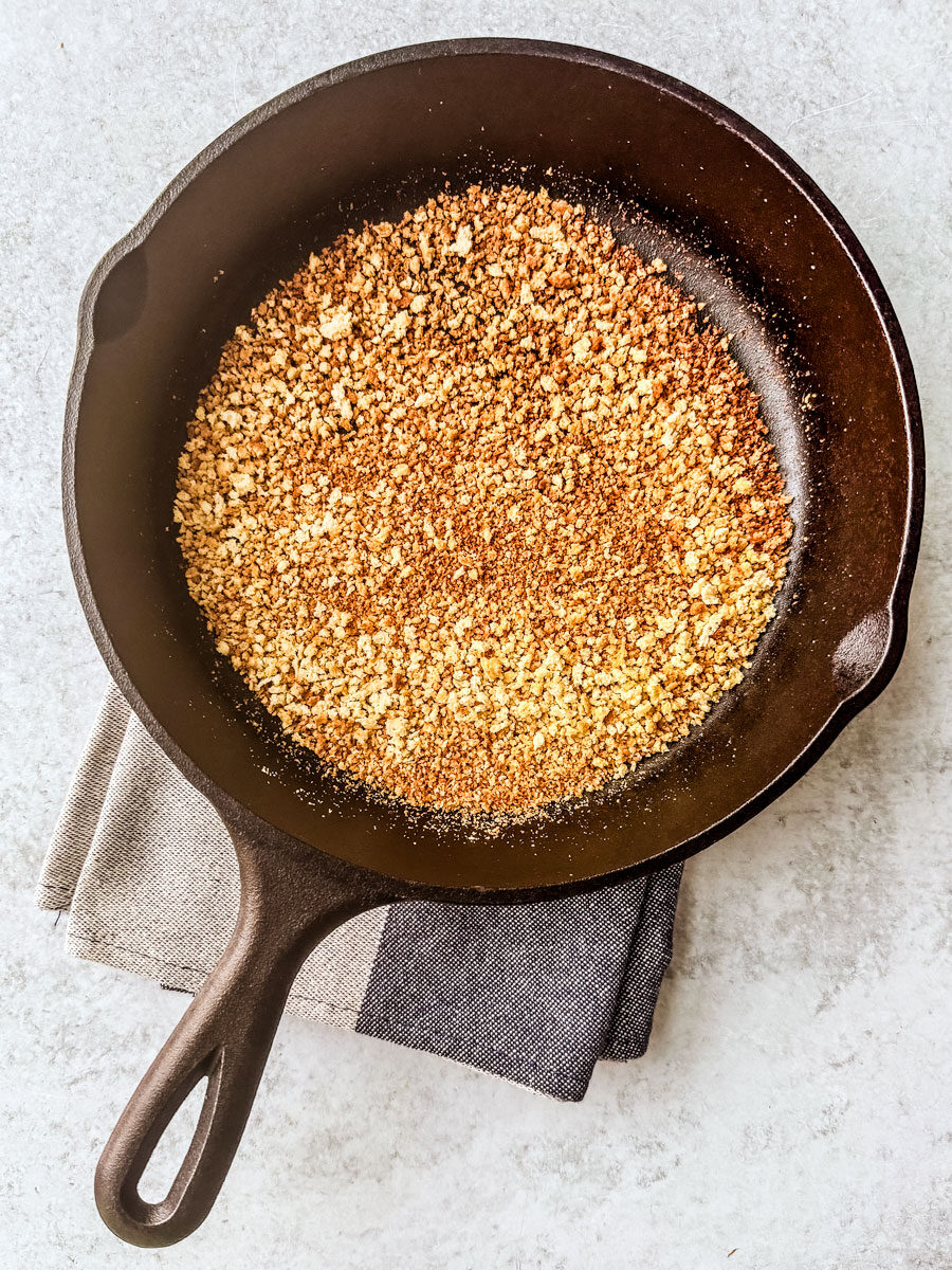 Cast iron pan full of toasted bread crumbs.