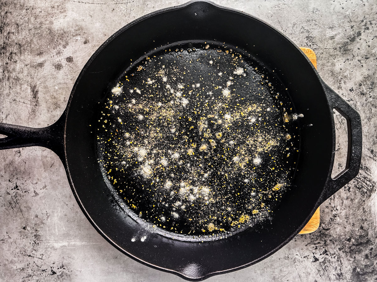 Cast iron pan sprinkled with cornmeal and flour.