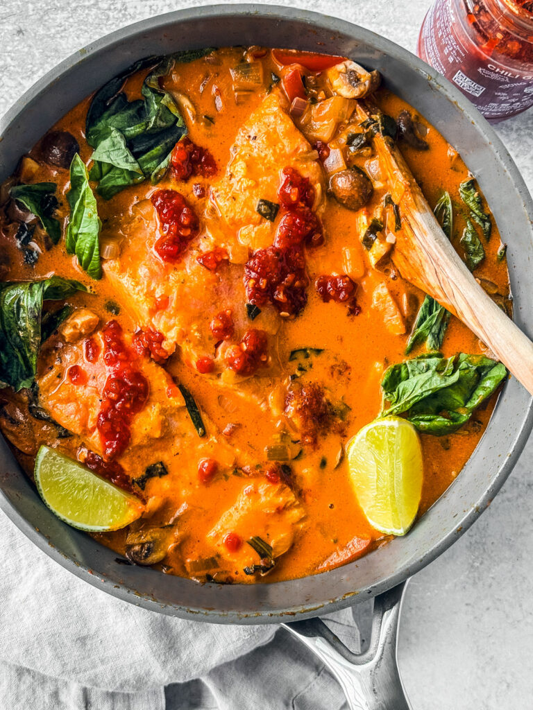 Curry salmon in coconut milk with basil, limes, and chili sauce.