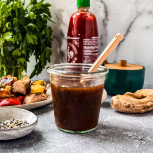 Teriyaki sauce in a jar on a countertop.