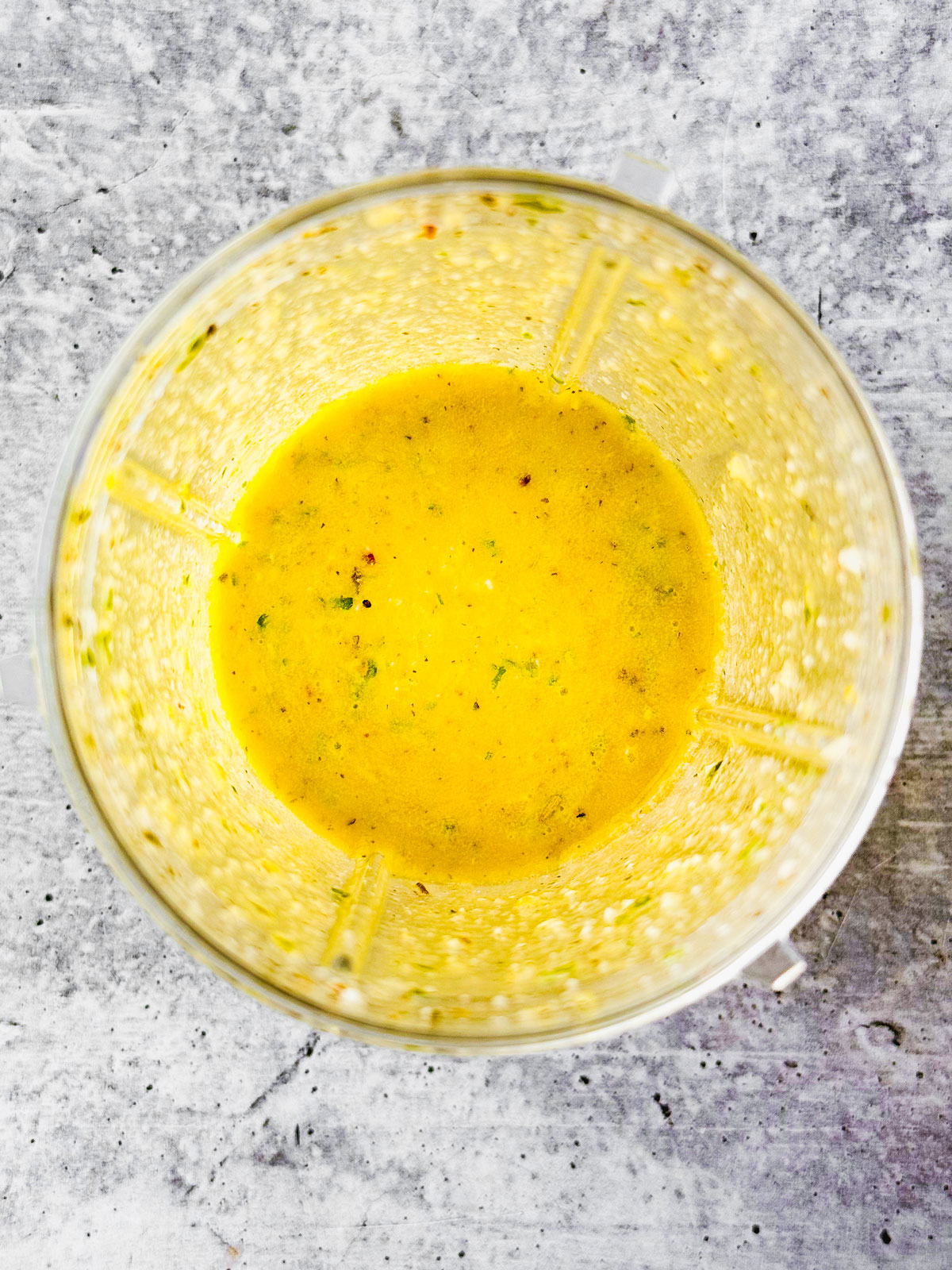 Lemon vinaigrette with honey fully blended in the blender.