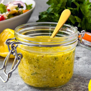 Small jar of feta lemon vinaigrette.