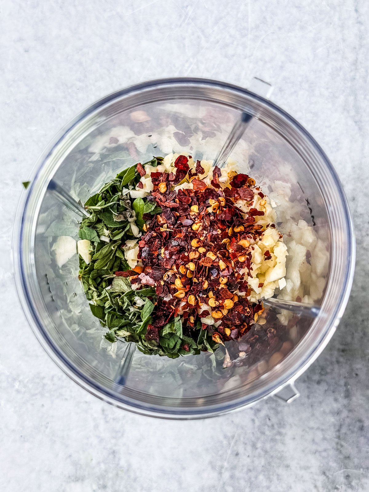 Chimichurri ingredients in a small bullet blender.