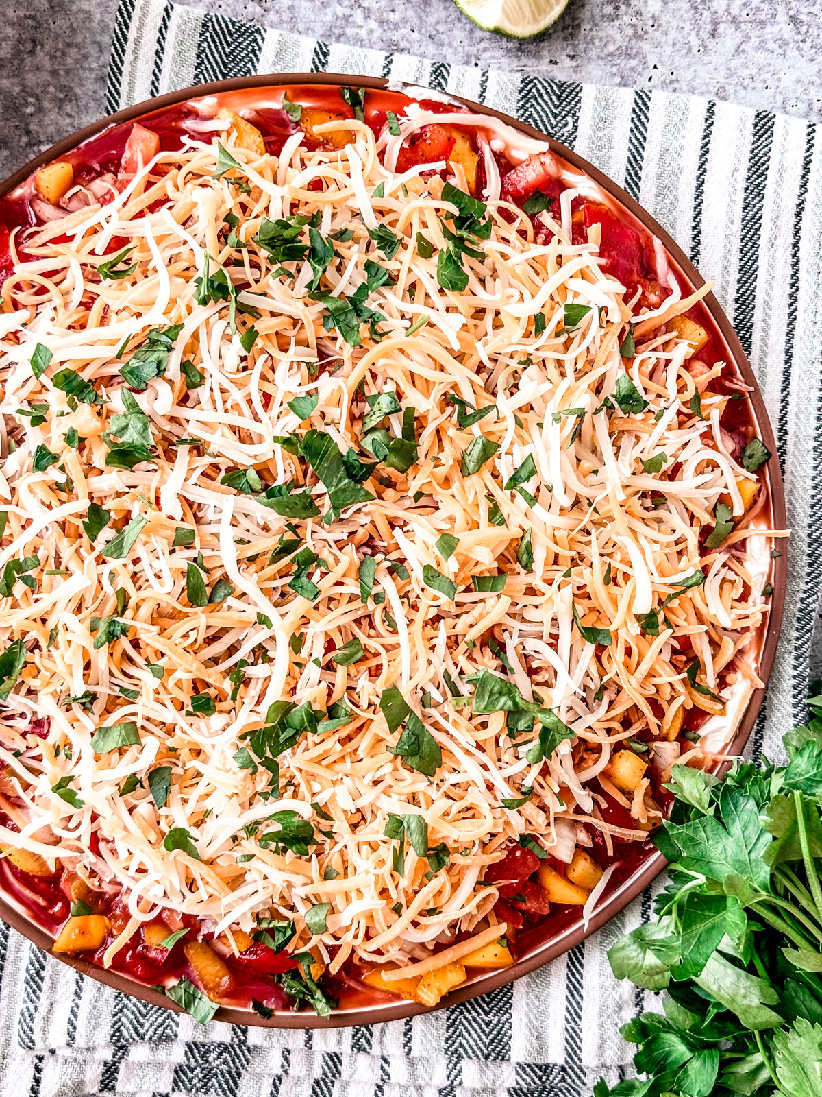 Taco dip garnished with fresh parsley.