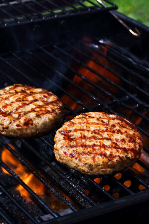 Turkey burgers on a grill.