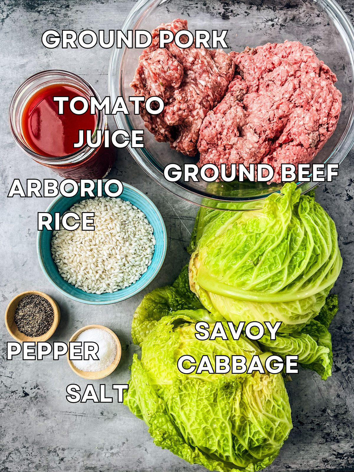 Ingredients for cabbage rolls on a grey background.