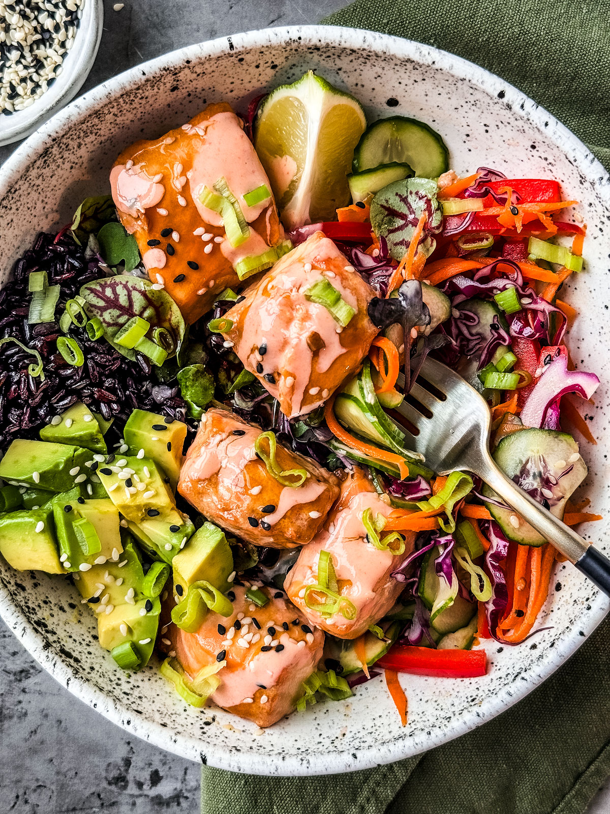 Bowl of teriyaki salmon with veggies and rice.