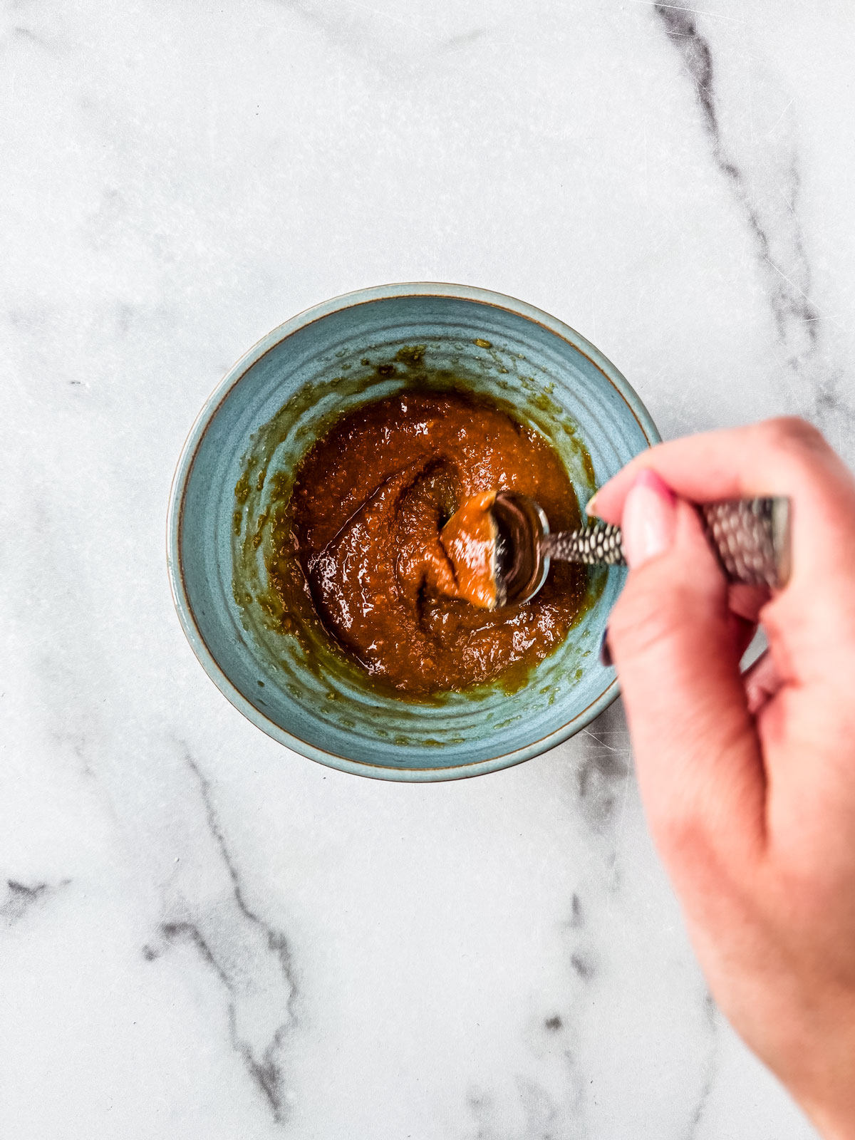 Miso paste being mixed in a small mixing bowl.