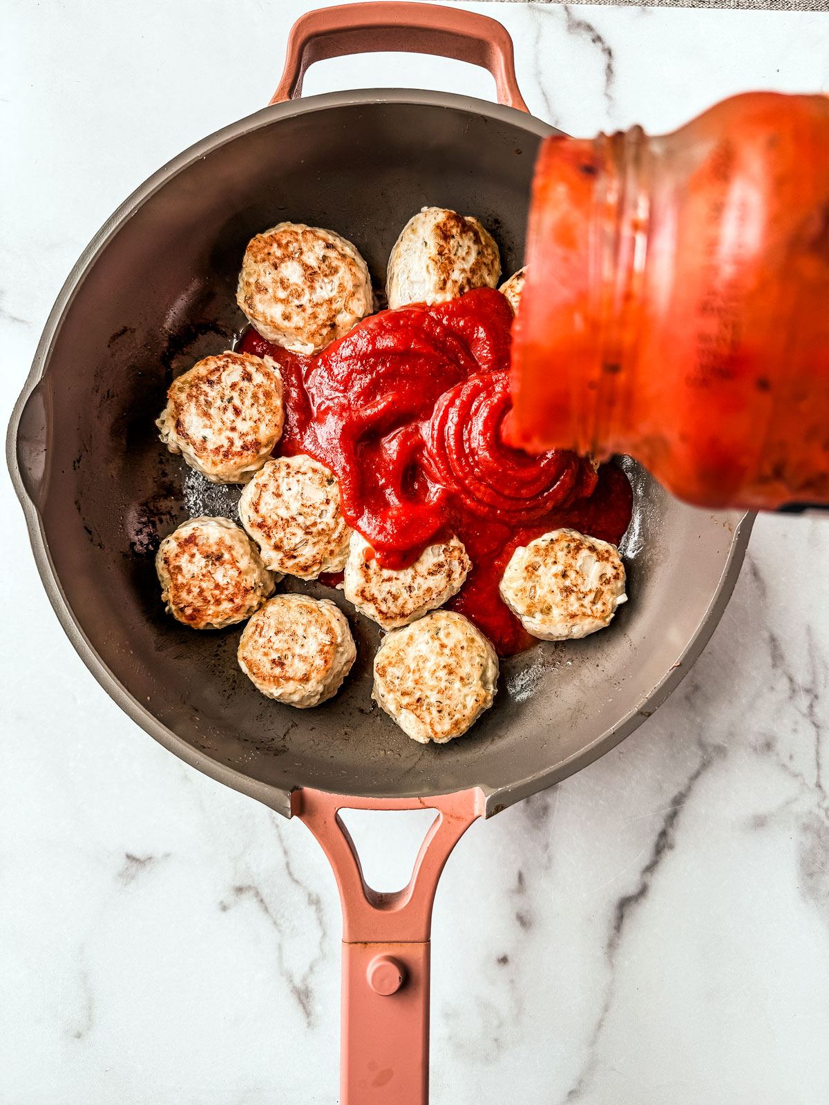 Meatballs lightly seared in a saucepan.