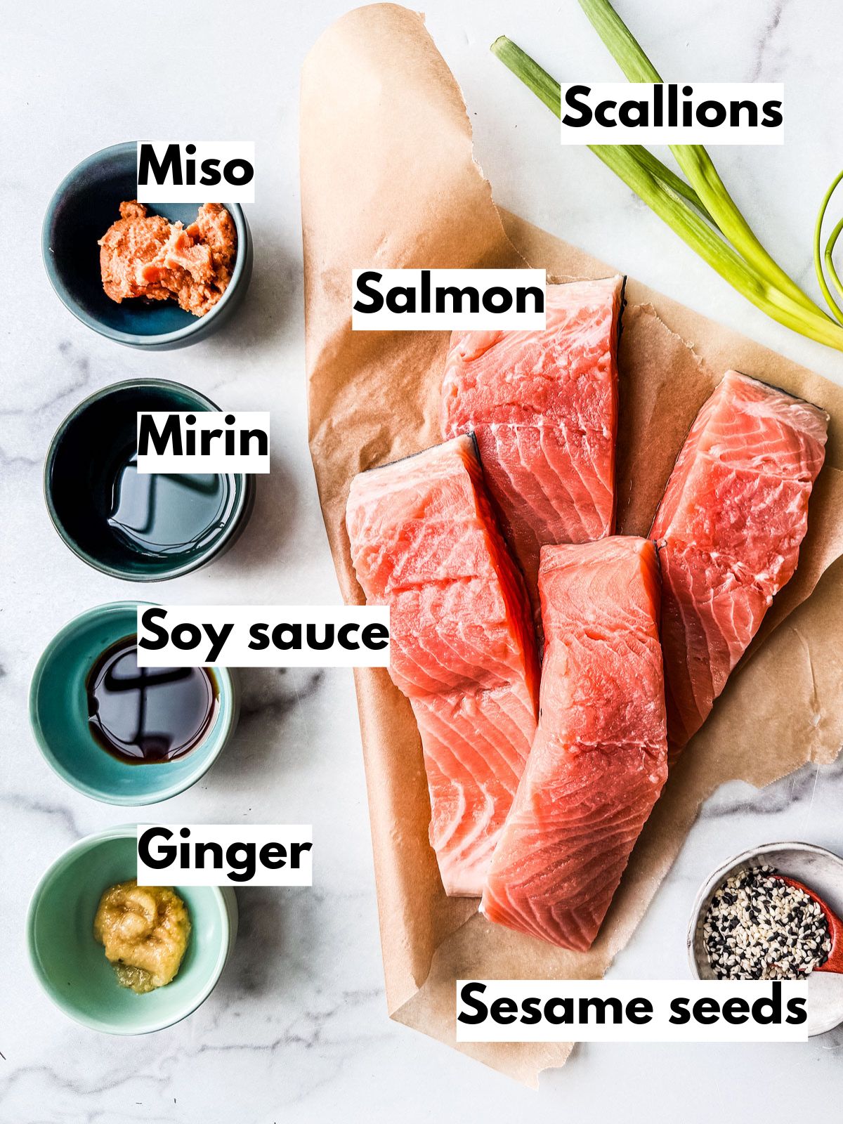 Ingredients for miso salmon on a white marble countertop.