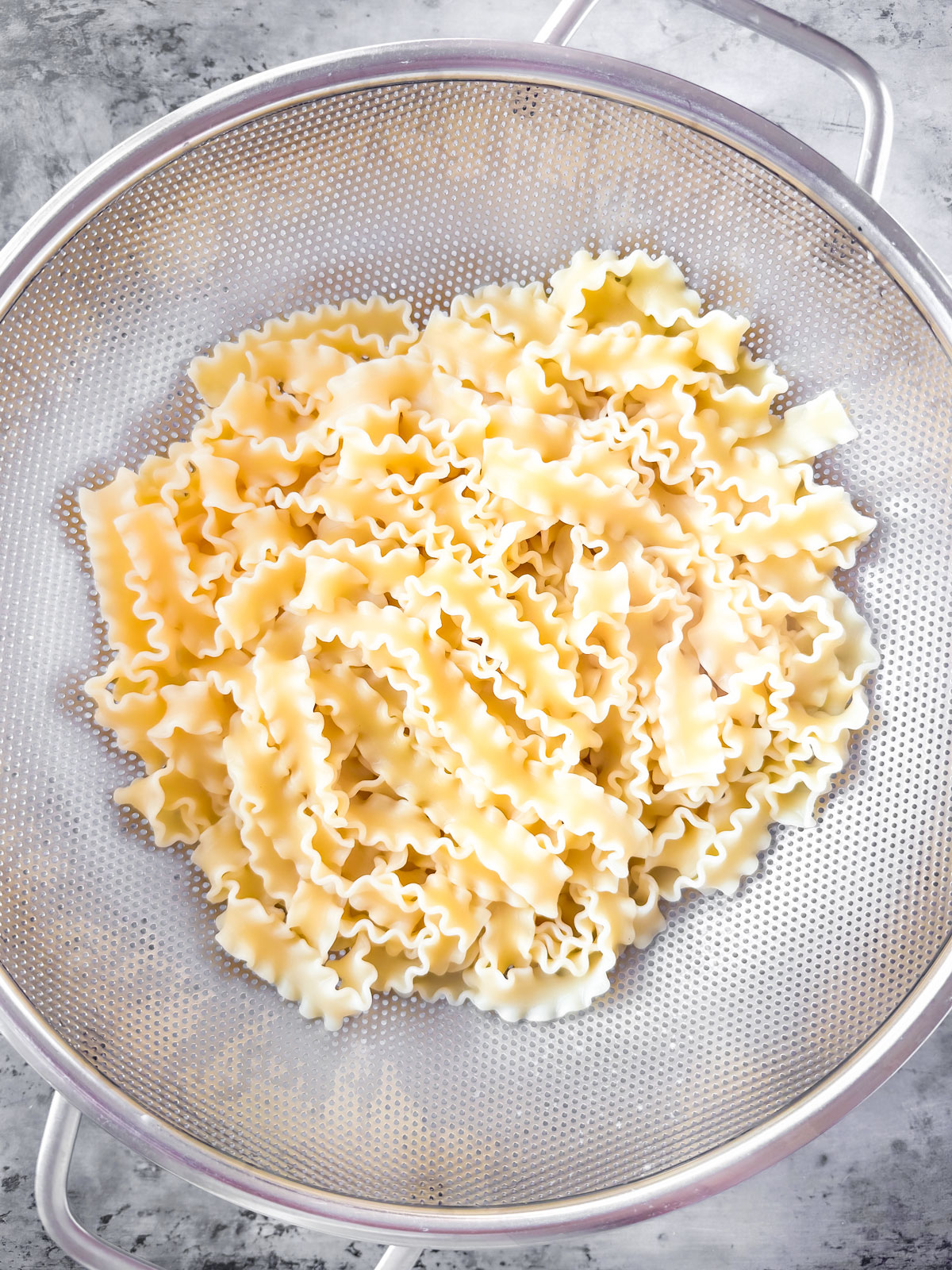 Noodles in a strainer.